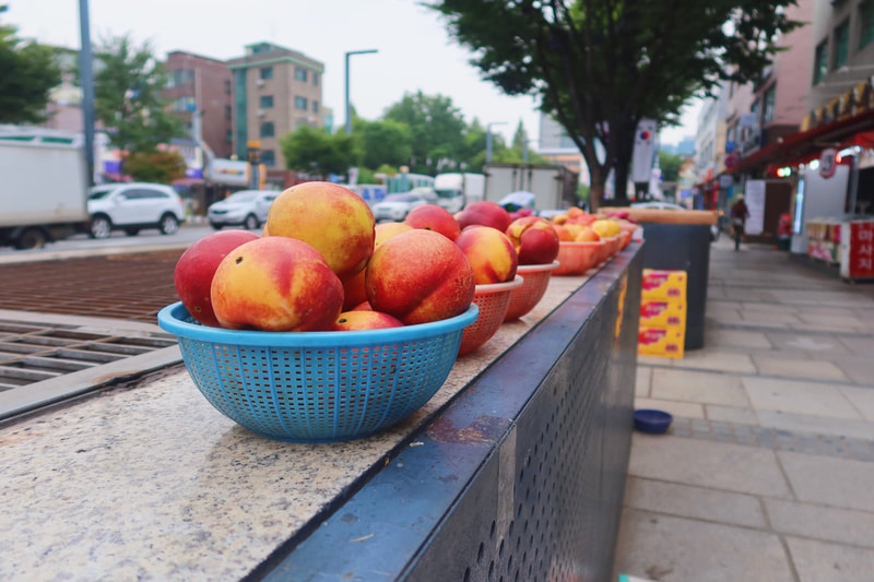 peaches for sale on the walk to the health center